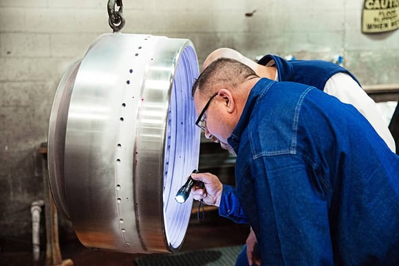 Separators technician examines bowl following minor centrifuge service visit