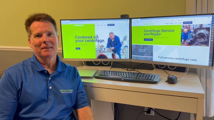 Separators' Kevin Burns sits smiling in front of computer screens